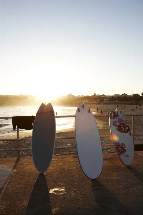 Framed Print : Surfboards leaning against railing