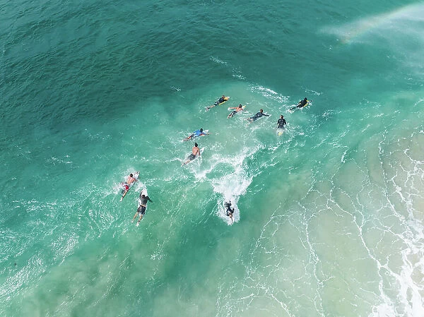 Surfers on the Coral Sea shot from a high angle perspective, Gold Coast, Queensland, Australia