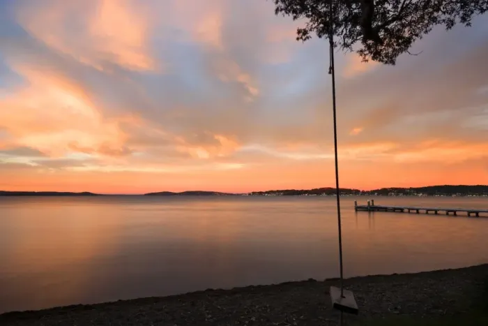 Framed Print : swing overlooking the lake at sunrise