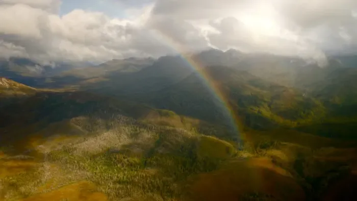 Framed Print : Tasmanian peaks with strong sunlight and rainbow