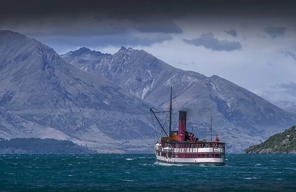 Traditional old working steamship making its way across lake Wakatipu, Queenstown on the South Island of New Zealand
