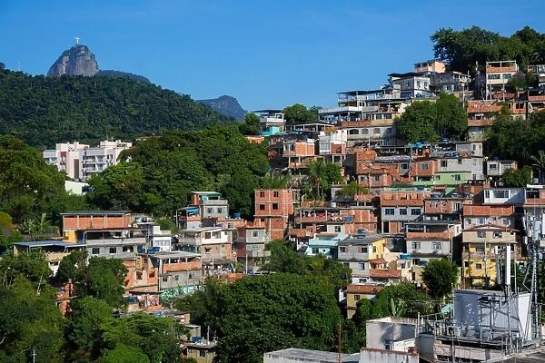 View Of Favelas in Rocinha and Christ The Redeemer At The Top Of Corcovado Mountain, Rio De Janeiro, Brazil, South America