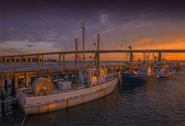 A warm sunrise sweeps over the wharf area at San Remo, Victoria