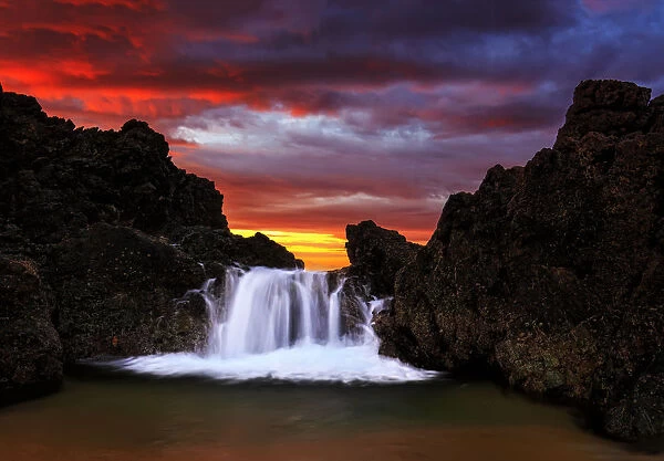 Water cascading over rock at sunrise