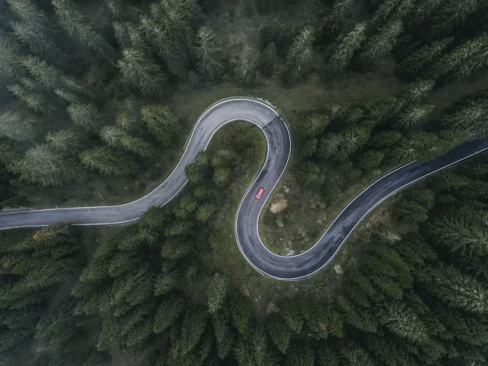 Framed Print : Winding forest road seen and a car shot by drone, Dolomites, Italy Framed Print : Winding forest road seen and a car shot by drone, Dolomites, Italy