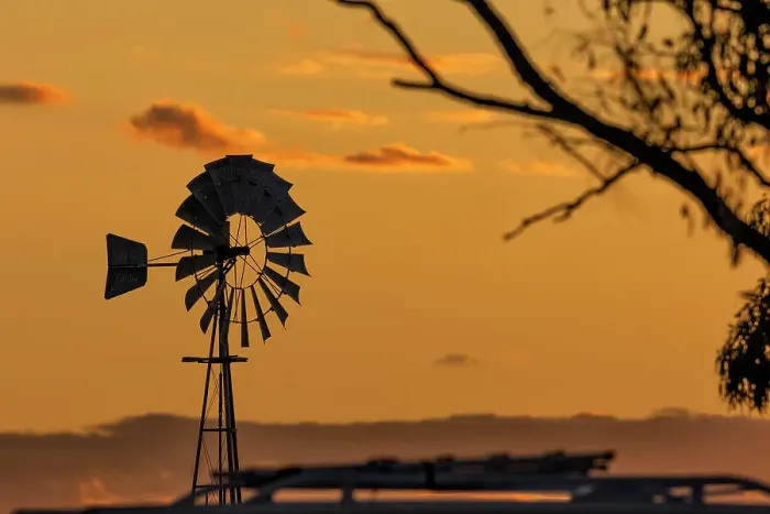 Framed Print : Windmill out in the country at sunset