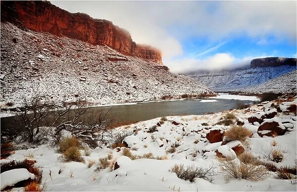 A winter mantle of snow lies along the banks of the Colorado river near Moab in Utah