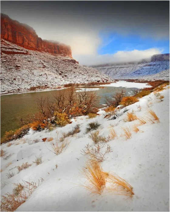 Framed Print : A winter mantle of snow lies along the banks of the Colorado river near Moab in Utah