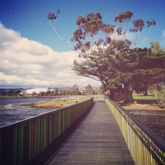 Framed Print : Wooden boardwalk beside river with colorful rails Framed Print : Wooden boardwalk beside river with colorful rails