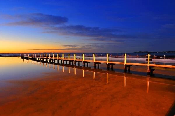 A wooden bridge before sunrise