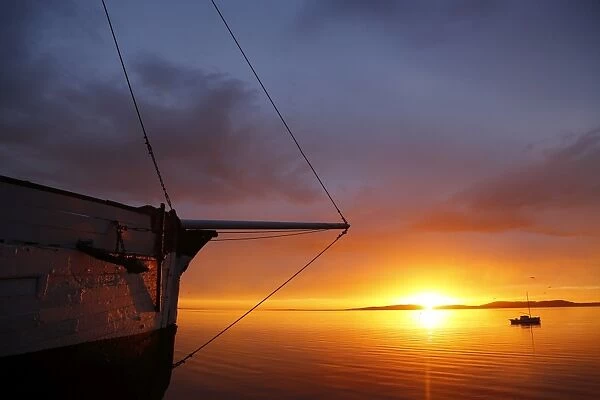 Wooden sailing boat and sunrise