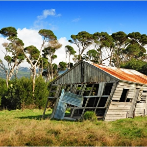 Abandoned and derelict old machinery shed in the rural farmland of Flinders Island, Bass Strait, Tasmania