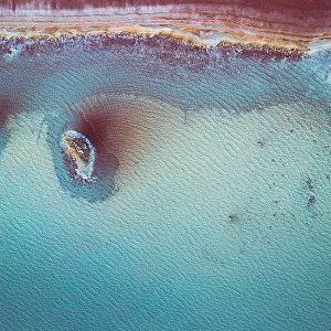 Aerial perspective at the edge of a vibrant coloured salt pool, Western Australia