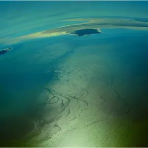 An Aerial view of the Australian outback in flood around Lake Eyre, showing the vibrant colours of the Landscape