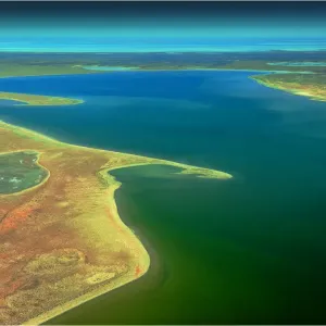 An Aerial view of the Australian outback in flood around Lake Eyre, showing the vibrant colours of the Landscape