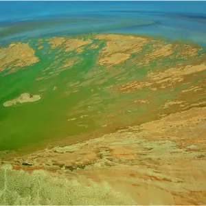 An Aerial view of the Australian outback in flood around Lake Eyre, showing the vibrant colours of the Landscape
