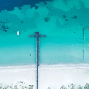 Aerial view of boat jetty on coastline