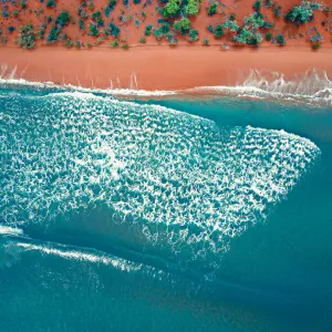 Aerial top view of a bright orange sandy beach