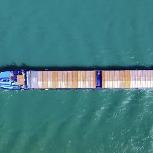 Aerial top view of a cargo container ship - transportation, import, export, logistics, commodity business in open sea Aerial top view of a cargo container ship - transportation, import, export, logistics, commodity business in open sea