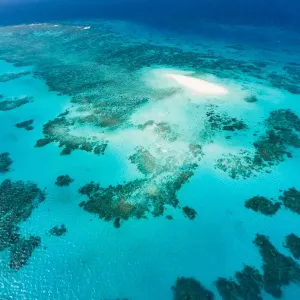 Aerial view of coral cay and Great Barrier Reef