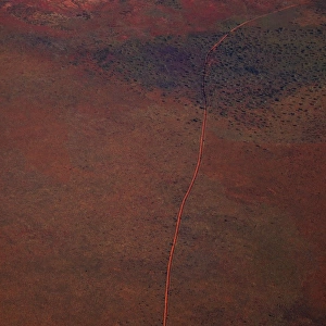 Aerial view of a dirt road positioned in a remote landscape