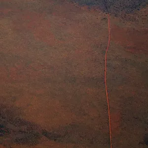 Aerial view of a dirt road positioned in a remote landscape Aerial view of a dirt road positioned in a remote landscape