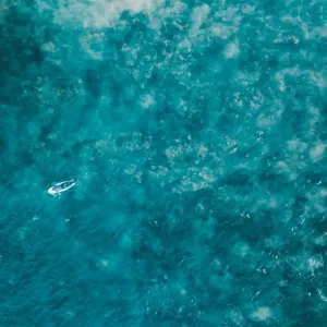 Aerial view of a female surfer on the ocean Aerial view of a female surfer on the ocean