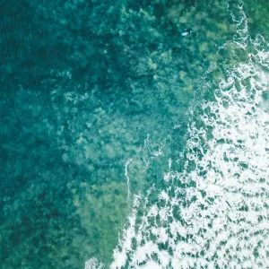 Aerial view of a female surfer on the ocean Aerial view of a female surfer on the ocean