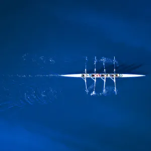 Aerial view of a rowing boat surrounded by classic blue water