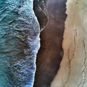 Aerial view of waves breaking on beach