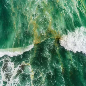 Aerial view of waves splashing in sea