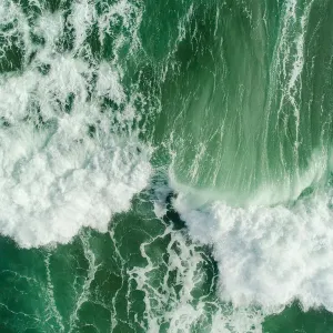 Aerial view of waves splashing in sea
