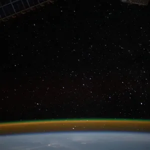 Airglow blankets the Earths horizon beneath a starry sky Airglow blankets the Earths horizon beneath a starry sky