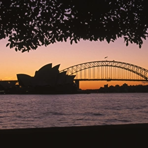Australia, New South Wales, Sydney, silhouette of Opera House and Sydney Harbour Bridge at sunset