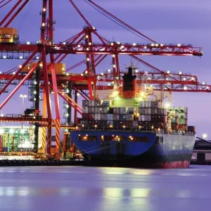 Australia, Victoria, Melbourne, container ship in shipyard, twilight
