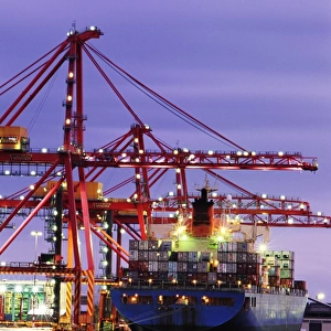 Australia, Victoria, Melbourne, container ship in shipyard, twilight
