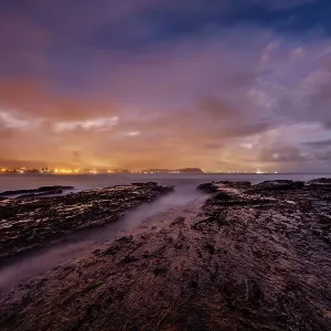 Beautiful twilights cloudy sunset over the textured rocks at Currumbin alley Beautiful twilights cloudy sunset over the textured rocks at Currumbin alley