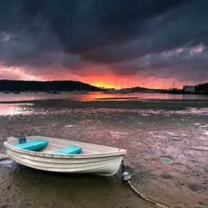 Boat on beach at sunrise