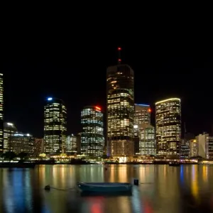 Brisbane by night city moon and dinghy Brisbane by night city moon and dinghy