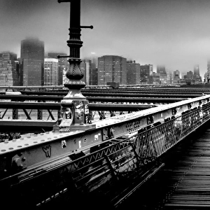 Brooklyn Bridge and Manhattan skyline under heavy fog in black and white
