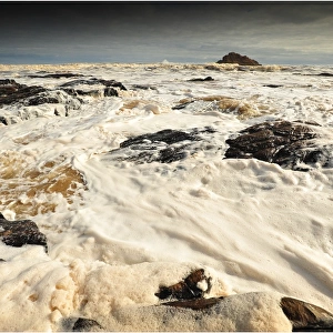Churning seas caused by tidal surge and river Tannins, west coastline of Tasmania, Australia