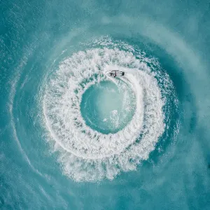 Circle patterns created by jet ski at sea as seen from directly above, Barbados Circle patterns created by jet ski at sea as seen from directly above, Barbados