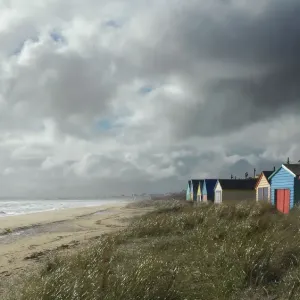 Clouds over Beach with Huts Print