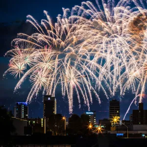 Colourful fireworks over city buildings