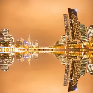 Composite image of city river and office and apartment buildings at dusk