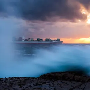 Container Ship sailing in to the Sunrise Container Ship sailing in to the Sunrise