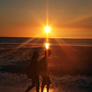 Couple on beach at sunset