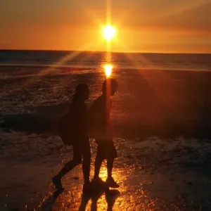 Couple on beach at sunset Couple on beach at sunset