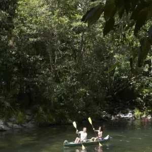 Couple kayaking on river Couple kayaking on river
