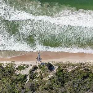 Desolate section of coast with nautical warning tower in foreground